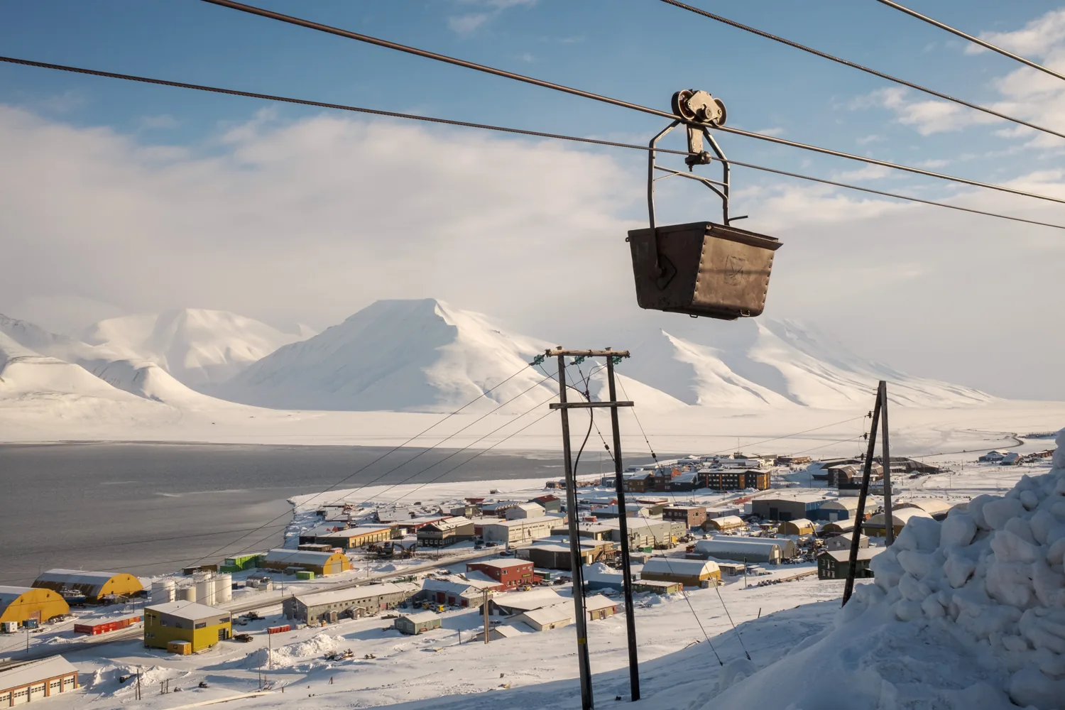 An old mining cable-car bucket hangs on wires above the town.