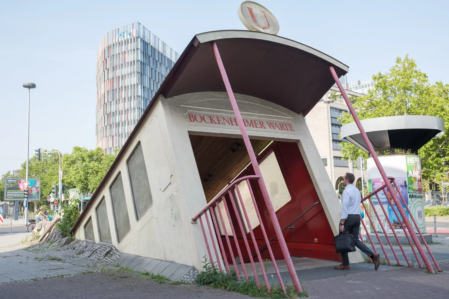 The tilted red entrance of the Bockenheimer Warte subway station.
