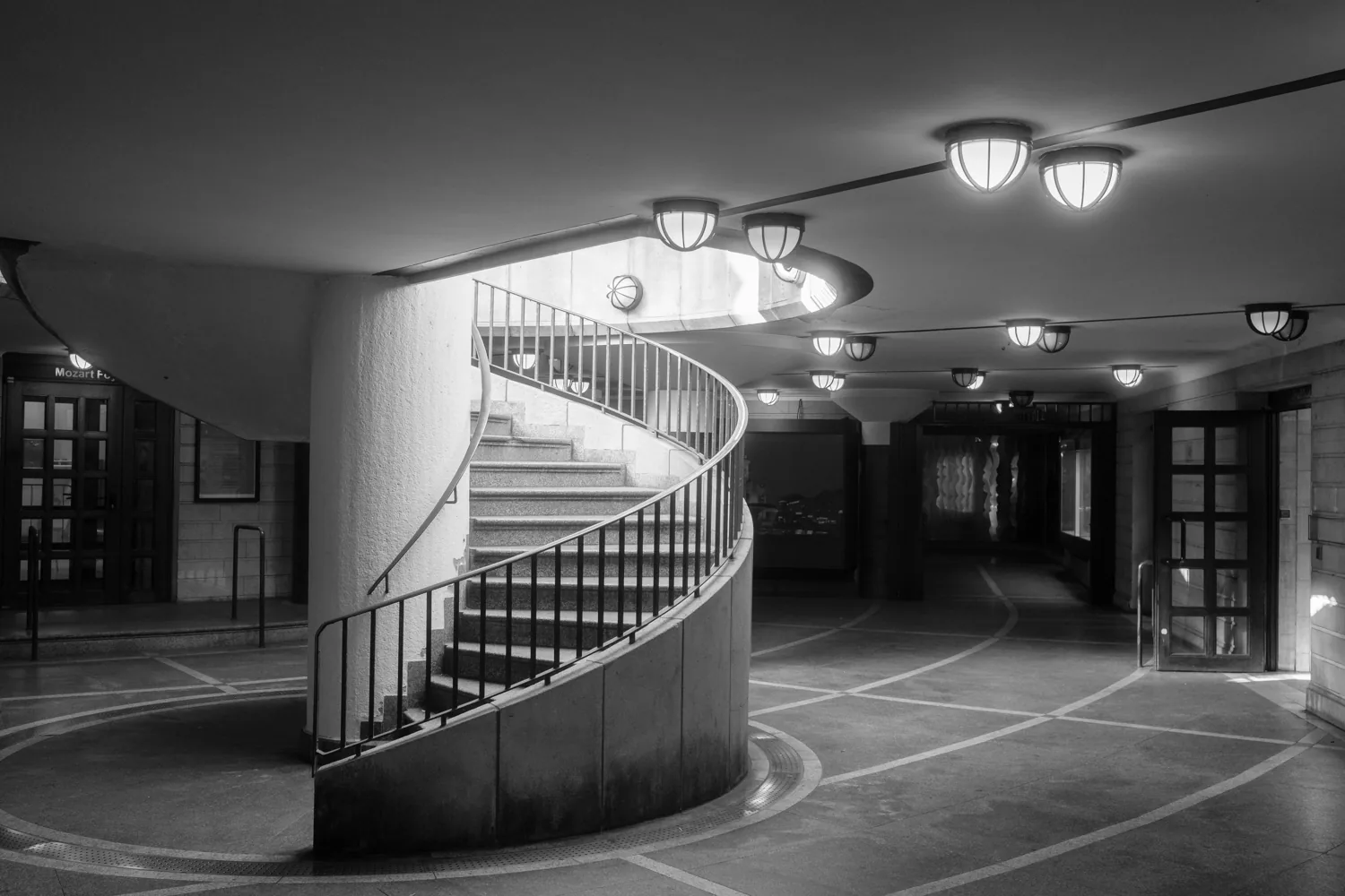 A spiral ramp curves through a concrete parking structure.